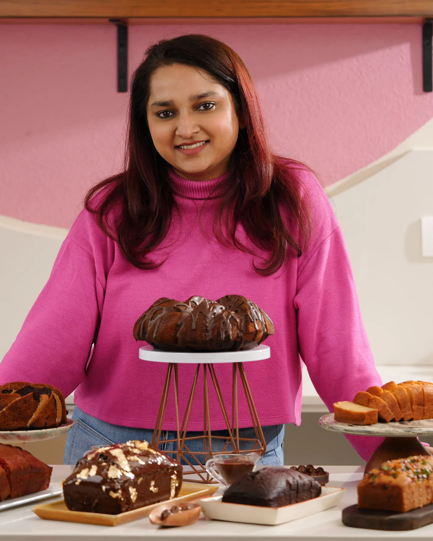 Anshita behind a counter of her tea cakes